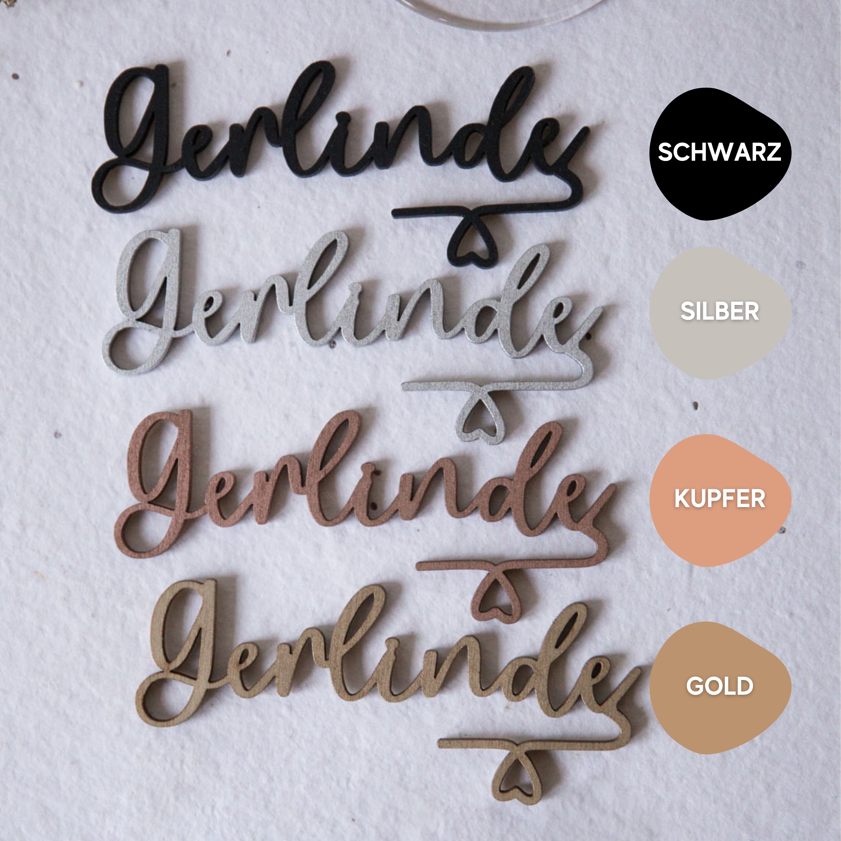 Vier stilvolle Glasmarkierer mit Namen „Gerlinde“ von Laserhelden in Schwarz, Silber, Kupfer und Gold auf hellem Hintergrund – personalisiert, ideal für Hochzeiten oder besondere Anlässe.